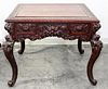 * A Chinese Carved Hardwood Game Table Height 30 x width 36 x depth 36 inches.