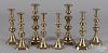 Four pairs of English brass candlesticks.