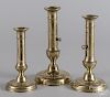 Three brass punch-up candlesticks, 19th c.