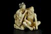 Vintage Netsuke carving of a woman cleaning a man's ear