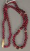 Cultured ruby and gold bead necklace. lg. 21in.