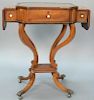 George III mahogany work table having opening leather top and sides with compartments, set on inlaid legs on four downswept m