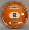 Mahogany day and date calendar, manually operated. dia. 14 1/2in.