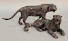 Two bronze tiger figures, one lying down (lg. 13 1/2in.) and the other walking (lg. 20in.).