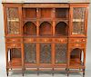 Mahogany etagere with brass rail, door, drawers, and shelves. ht. 59in., wd. 64 1/2in., dp. 14in.