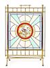 A Victorian Brass, Stained and Caned Glass Fireplace Screen, Height 35 1/4 x width 24 5/8 inches.