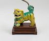 CHINESE YELLOW AND GREEN GLAZED MODEL OF A BUDDHISTIC LION MOUNTED AS A LAMP