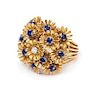 * An 18 Karat Yellow Gold, Diamond and Sapphire Articulated Flower Ring, 8.10 dwts.