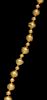 * An Akan Gold Alloy Bead Necklace, CÃ™te d'Ivoire/Ghana, strung with 31 round beads in alternating sizes.