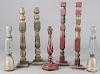Seven carved and painted candlesticks