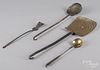 Four wrought iron and brass kitchen utensils.