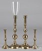 Two pairs of brass candlesticks and a shade