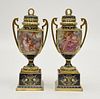 Pair of Royal Vienne covered urns on pedestals