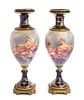 A Pair of Gilt Bronze Mounted Sevres Style Porcelain Urns Height 24 inches.