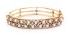 * A 14 Karat Yellow Gold, Sapphire and Cultured Pearl Bangle Bracelet, 21.10 dwts.