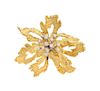 * An 18 Karat Bicolor Gold and Diamond Floral Motif Brooch, 14.20 dwts.