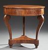 French Empire Style Carved Walnut Circular Table, 19th c., the circular top over a wide skirt with two frieze compartment dra