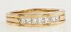 Man's 14K Yellow Gold Dinner Ring, the center with a row of 7 channel set princess diamonds, on a ribbed band, total diamond 