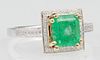 Lady's 14K White and Yellow Gold Dinner Ring, with a 2.07 carat cushion cut emerald atop a border of tiny round diamonds, the