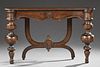 Continental Style Carved Mahogany Console Table, 20th c., the stepped cookie corner top on large turned tapered front legs, a