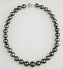 Stand of Thirty-Three Graduated Dark Grey Tahitian Cultured Pearls, ranging from 12-14 mm, with a 14K white gold ball clasp, 