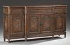 Louis XVI Style Carved Mahogany Sideboard, 20th c., the rounded edge breakfront top over a center long frieze drawer above tw