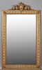 French Gilt and Gesso Pine Renaissance Style Overmantle Mirror, 19th c., the winged dragon and shield crest over a reeded fra