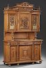 French Henri II Carved Oak Buffet a Deux Corps, early 20th c., the arched crest over a carved crown flanked by spindled galle