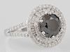 Lady's 14K White Gold Dinner Ring, with a 3.31 carat round black diamond, atop a triple concentric graduated border of round 