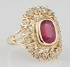 Lady's 14K Yellow Gold Dinner Ring, with an oval 3.28 carat ruby on a twist carved border over a pierced outer border, mounte
