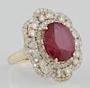 Lady's 14K White Gold Dinner Ring, with an oval 9.61 carat ruby atop a double graduated concentric border of round diamonds a