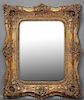 Rococo Style Gilt Overmantle Mirror, 20th c., the stepped frame with relief floral and leaf mounts, around a rectangular beve