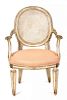 A Directoire Style Parcel Gilt Caned Oval Back Fauteuil Height 36 1/2 inches.