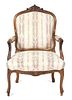 A Louis XV Style Carved Walnut Fauteuil Height 37 inches.