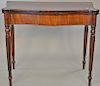 Sheraton mahogany game table on fluted legs. ht. 30 in., wd. 35 in., dp. 18 in.