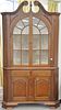 Mahogany centennial two part corner cupboard with shell carved top. ht. 97 in., wd. 54 in., dp. 28 in.  Provenance: From the 