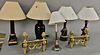 Group of five table lamps, hts. 21in. to 26in., and pair of brass chenets (one lamp as is). ht. 12in., wd. 15in.   Provenance