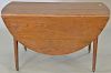 Oak drop leaf table. ht. 27 in., top closed: 21" x 54"   Provenance: The Estate of Thomas F Hodgman of Fairfield, Connecticut
