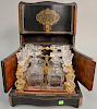Tantalis having ebonized case with four decanters and fourteen stems (lot damage). ht. 10 1/2 in., wd. 12 in., dp. 9 3/4 in. 