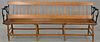 Railroad plank seat bench with iron arms and reversible back. lg. 84 in.  Provenance: Property from the Estate of Frank Perro