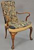 Queen Anne style open armchair with needlepoint upholstery.