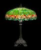* Wilkinson Co., EARLY 20TH CENTURY, a leaded glass table lamp, the domed shade with floral lower border, raised on a cast me