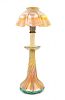 Tiffany Studios, EARLY 20TH CENTURY, a Favrile glass candlestick lamp, in gold iridescence, having ruffled shade and twist ba