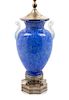 Steuben, FIRST HALF 20TH CENTURY, a blue Cluthra glass lamp, with opaline handles.