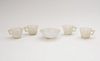 SET OF FOUR CHINESE SMOKEY GREY JADE HEXAFOIL CUPS AND A PALE JADEITE FOOTED DISH