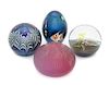 * Four Iridescent Glass Paperweights Diameter of largest 3 1/2 inches