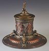 French Copper and Brass Classical Style Inkwell, 19th c., the lid with a relief female figural handle, over a pressed glass i