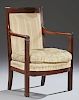 American Classical Style Carved Walnut Armchair, 19th c., the curved tablet crest rail over an upholstered back to rounded ar