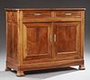 French Louis Philippe Carved Walnut Sideboard, 19th c., the canted corner top over two frieze drawers above double cupboard d