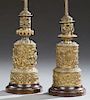 Near Pair of Brass Repousse Parcel Lamps, 19th c., with frolicking putti decoration, on turned wooden bases, now electrified,